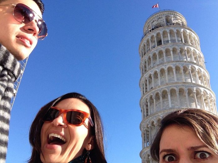 three people in front of the leaning tower of pisa