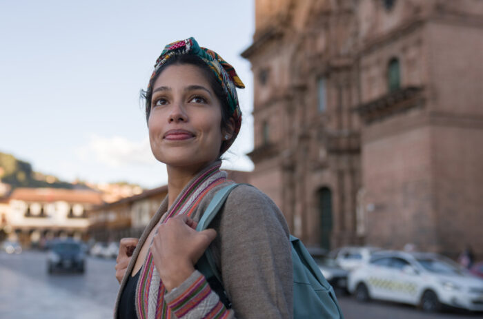 Happy woman sightseeing around Cusco around the Cathedral in Cusco