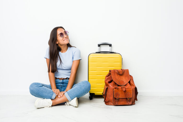 woman smiling with luggage and backpack